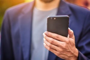 Businessman Holding Cell Phone Using Mobile Phone Or Smart Phone