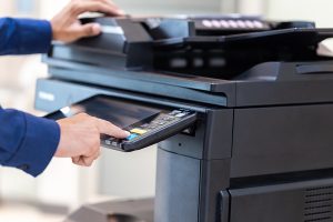 Businessman press button on panel of printer photocopier network , Working on photocopies in the office concept , printer is office worker tool equipment for scanning and copy paper.