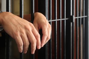 prisoner behind bars