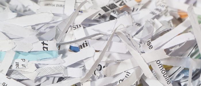 The Risks Behind Letting Remote Employees Handle Document Destruction Shredded paper in a cardboard box for packaging