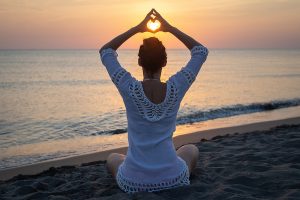 Woman doing yoga in nature. Yoga in nature. Yoga lifestyle. Healthy lifestyle. Woman doing yoga on beach in sunset. Yoga healthy lifestyle. Happy people. Healthy people. Young people. Yoga outdoors in nature on beach.