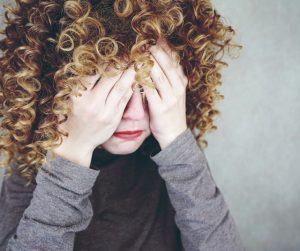 child covering eyes