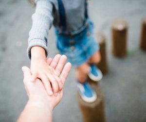 parent holding childs hand